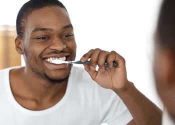 a man brushing his teeth