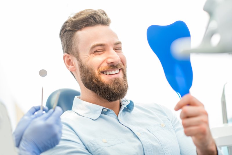 patient smiling after getting veneers