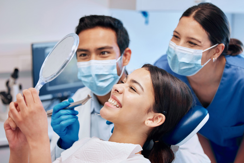 Patient checking their teeth after cosmetic dentistry